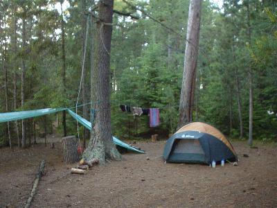 Portion of our White Otter Castle campsite featuring Doug and Martin's tent, our shelter tarps and our rope system for putting the food up in a tree.